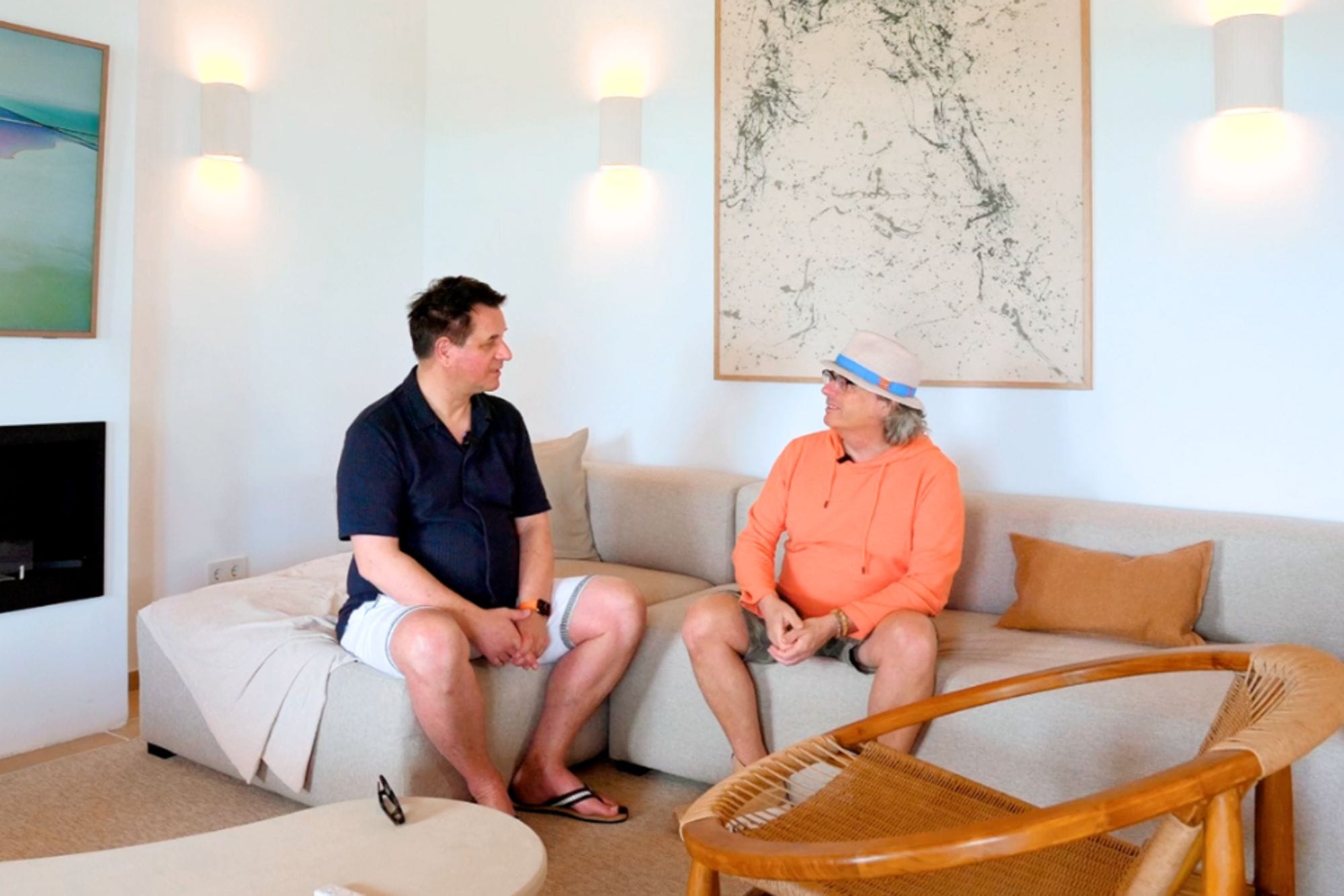 Two men sitting on the couch in their villa in Mallorca.