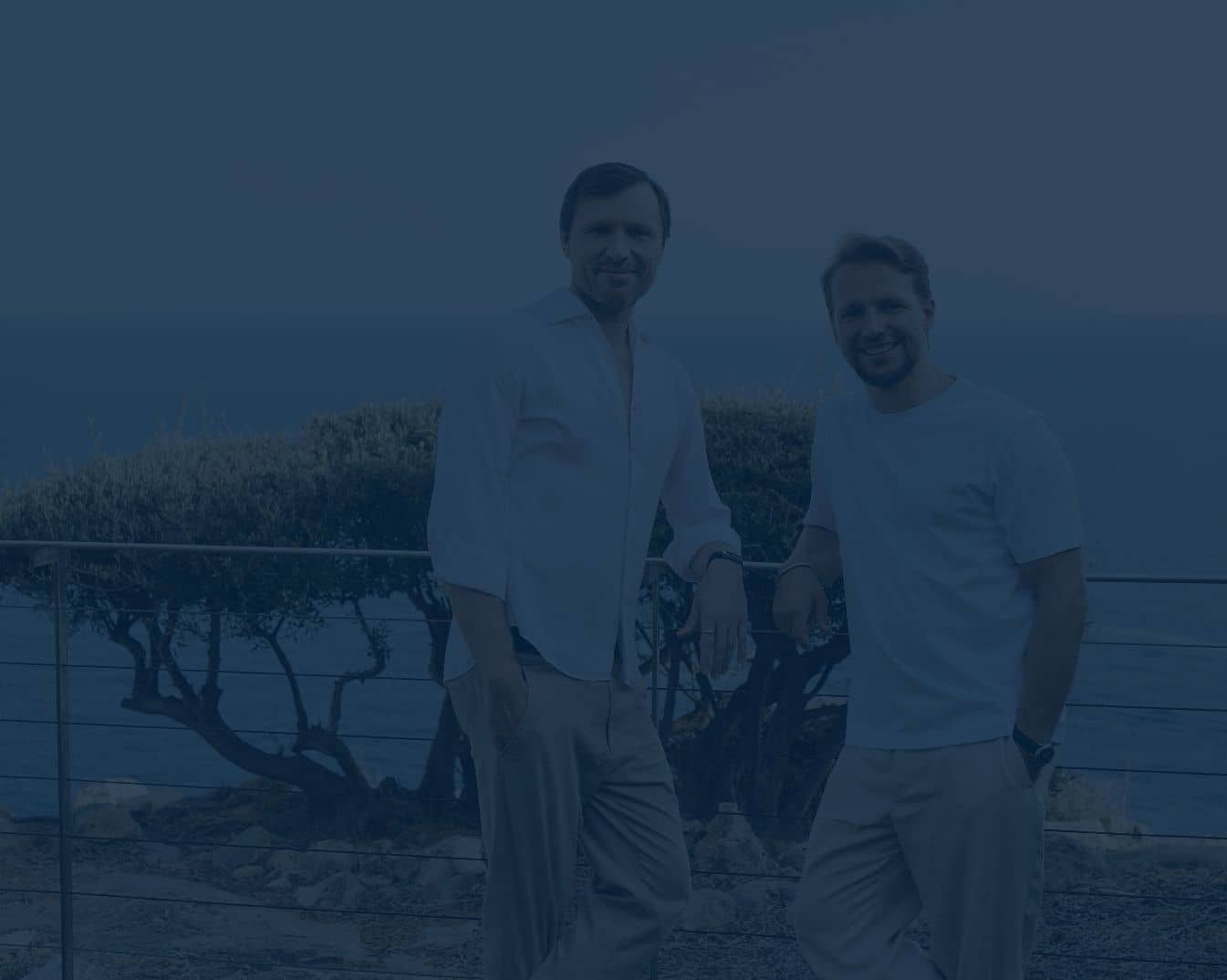 Two men smiling at the camera