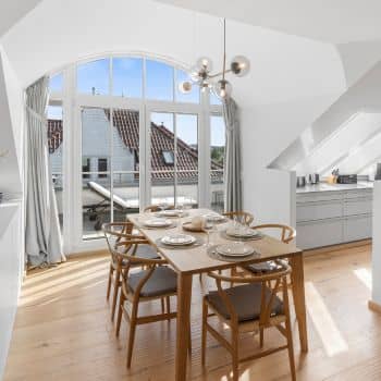 Modern dining room of a penthouse by the Baltic Sea.